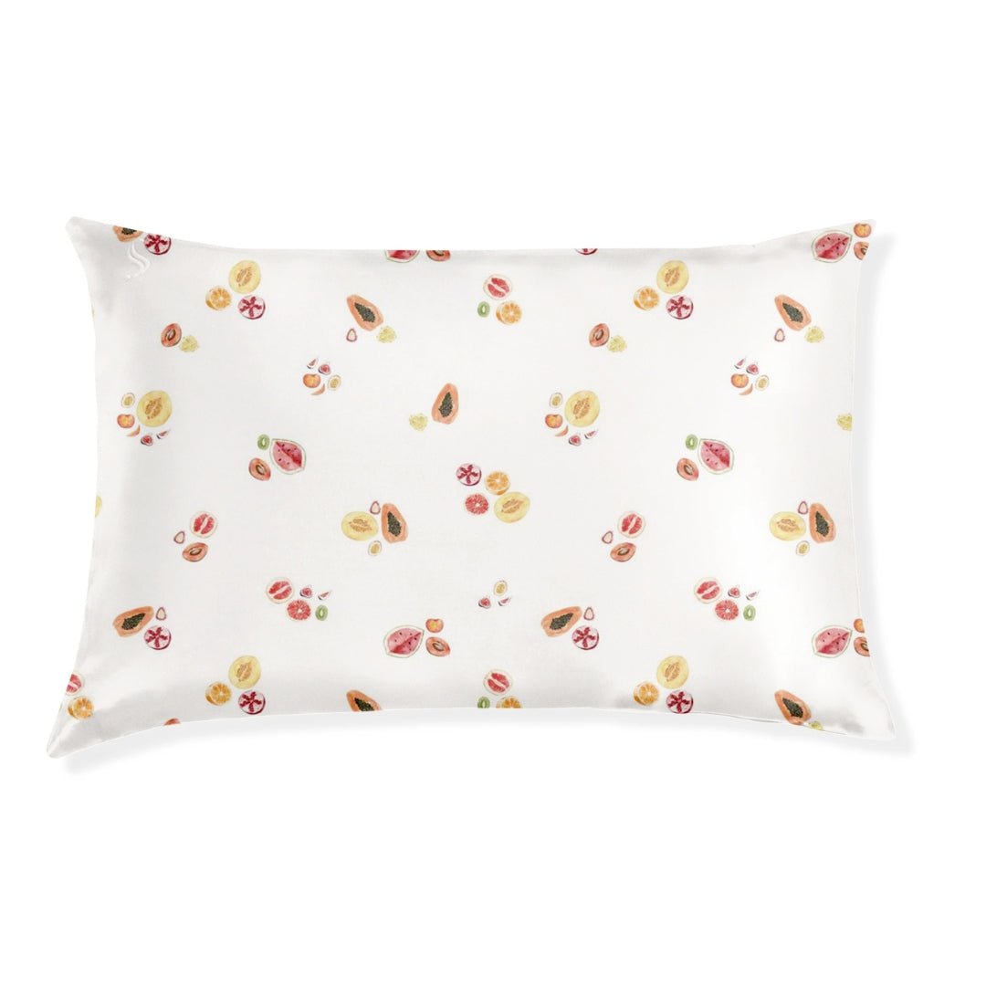 A white silk pillowcase with a floral pattern.