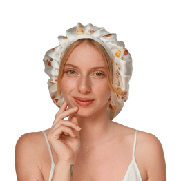 A woman wearing a white silk bonnet with a floral pattern.